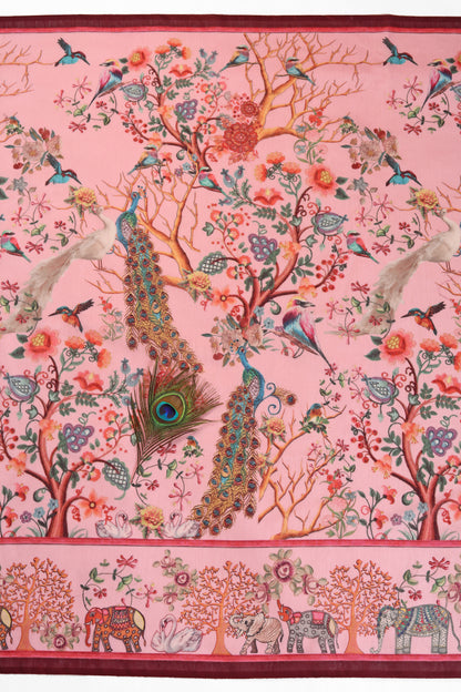 Decorative fabric with peacocks, trees, and elephants on a pink background Madhuri Van Chanderi Cotton Saree | Yuvani Vesture