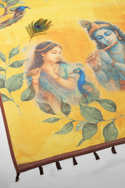 Painting of a woman holding a peacock next to a deity on a yellow background with leaves. Mor Bansi Yellow Chanderi Saree | Yuvani Vesture