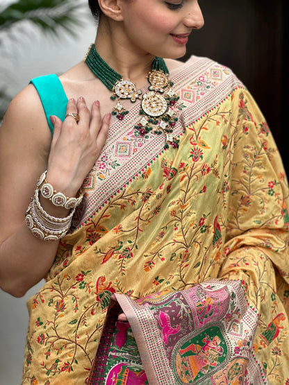 Woman wearing a traditional embroidered saree with jewelry Peetambari Meenakari Jacquard Floral Print Saree | Yuvani Vesture