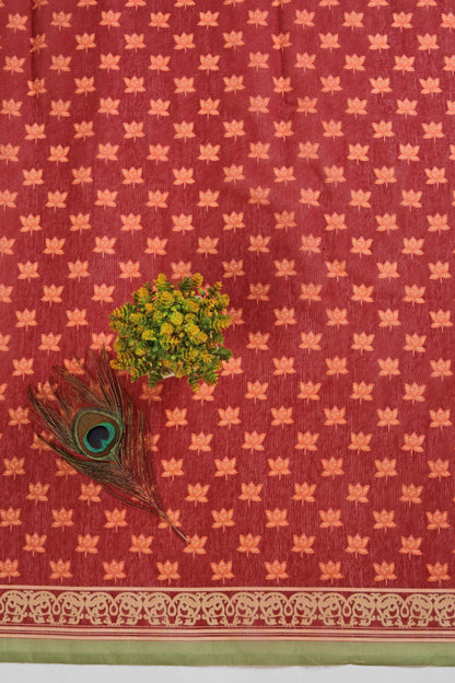 Red fabric with gold leaf pattern, green leaves, and peacock feather on a white background Radha Ridhaya Chanderi Saree | Yuvani Vesture