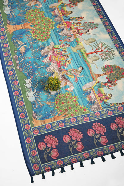 A Chanderi cotton saree with a floral and divine figure pattern, predominantly blue, with a tassel detail on the edge. Tarangini Chanderi Saree | Yuvani Vesture