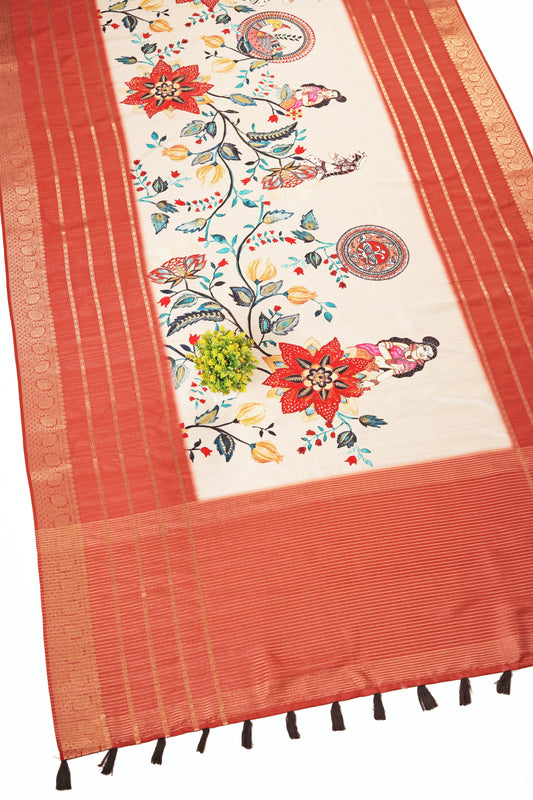 An off-white silk saree with a floral jacquard design and a rust-colored border with golden stripes. The saree has ornamental tassels on the lower edge. Vasundhara Jacquard Silk Floral Print Saree | Yuvani Vesture