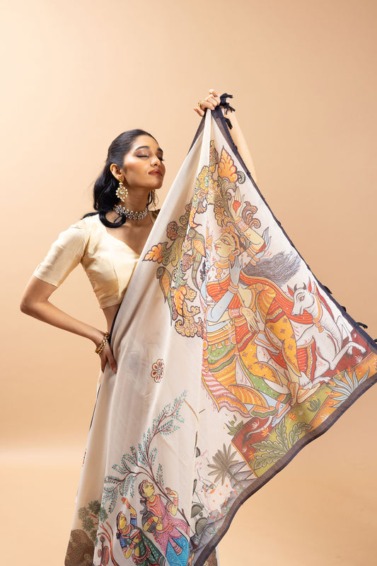 Woman holding a colorful saree with intricate designs on a beige background Vrindavan Vaas Chanderi Saree | Yuvani Vesture